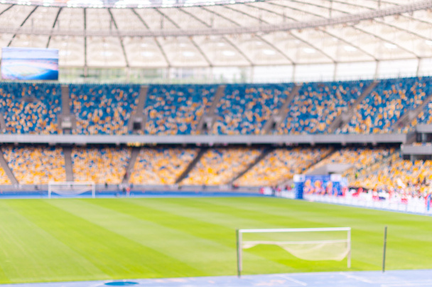 Homályos zsúfolt labdarúgó-stadion, állványok, és a nézők. sport 2016-ban háttér - Fotó, kép