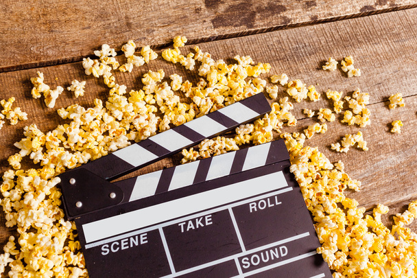 Movie clapperboard and popcorn  - Photo, image
