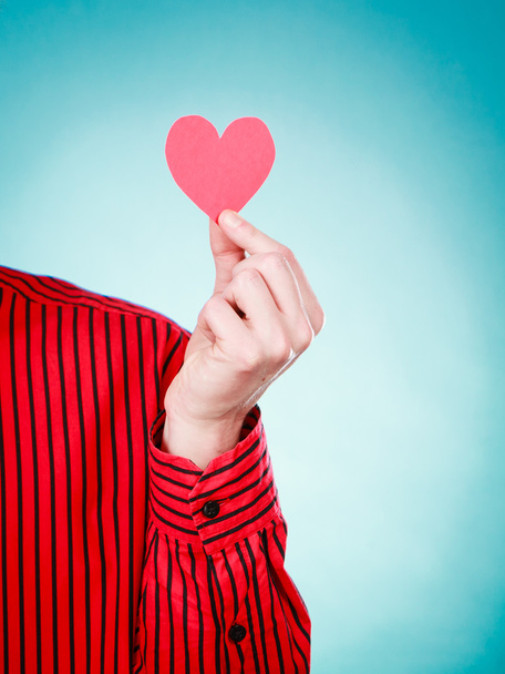 Person holding heart cutout. - Foto, Bild