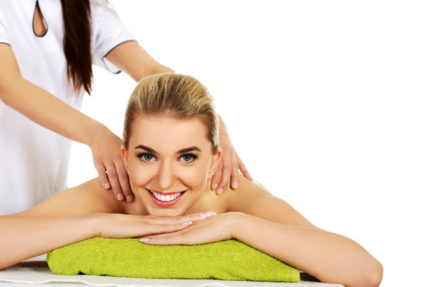 Young smile woman lying on a massage table and has massage. - Foto, Imagen