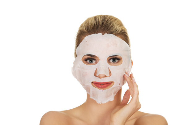 Young happy woman with facial mask. - Foto, immagini