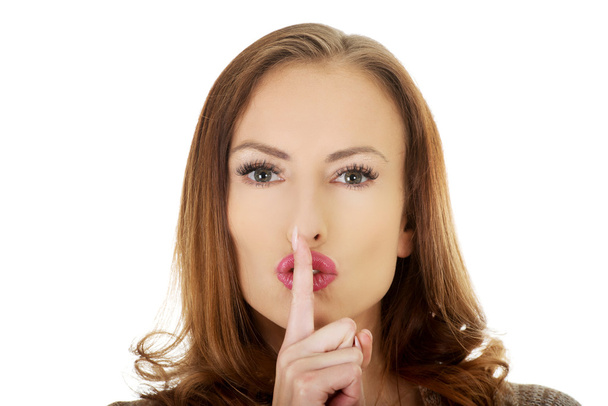 Woman placing finger on lips. - Photo, image