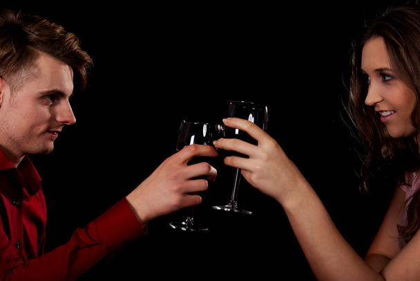 Couple with wine by a table. - Фото, изображение