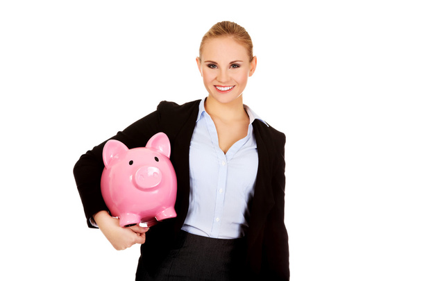 Young business woman holding  piggybank - 写真・画像