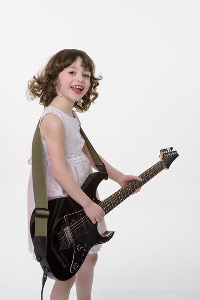 Happy child plays the guitar - Фото, изображение