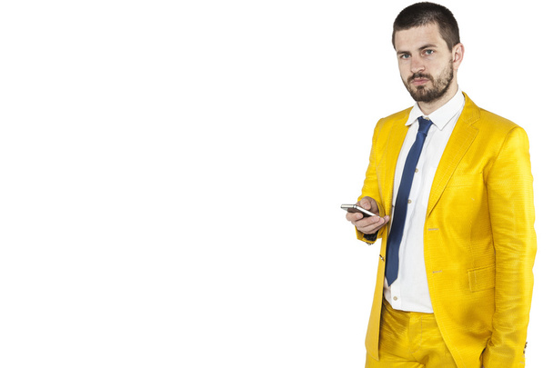 businessman holding a phone in his hand and looking at you - Photo, Image