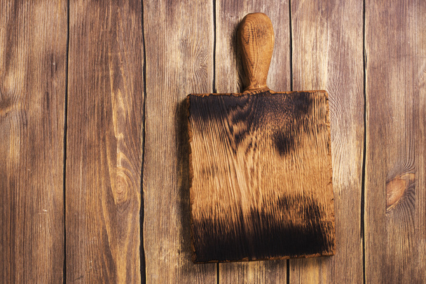 Vintage cutting board over wooden background - Foto, Imagen