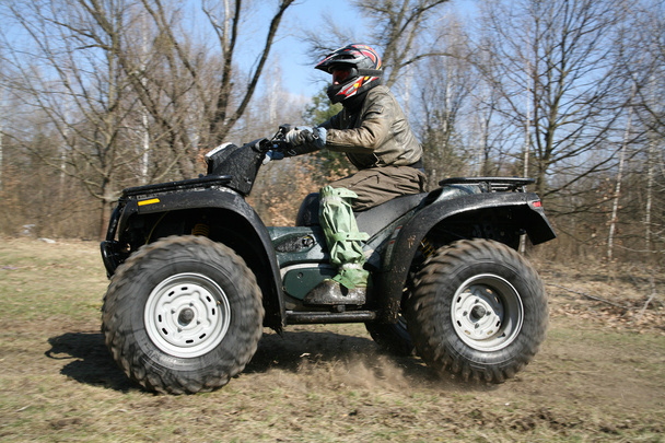 The man goes on ATV in the spring - Photo, Image