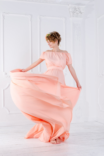 Woman dancing in pink evening dress flying on wind. Waving fabric, fashion shot. - Photo, Image
