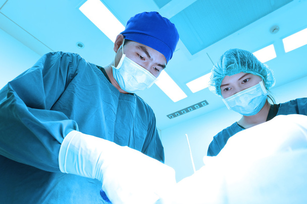 two veterinarian surgeons in operating room  - Foto, Imagen