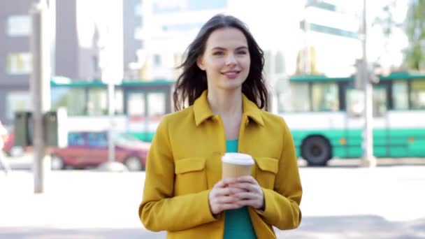 happy young woman drinking coffee on city street - Video