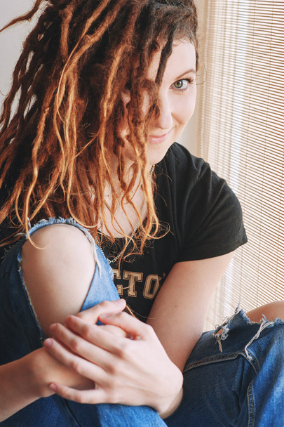 Portrait of a young woman with dreadlocks on his head - Photo, Image