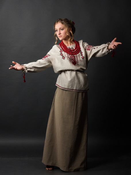 Dancer. Beautiful happy cute young woman in Ukrainian embroidery dancing  - Photo, Image