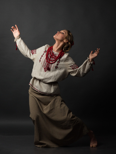 Dancer. Beautiful happy cute young woman in Ukrainian embroidery dancing  - Фото, изображение