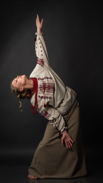 Dancer. Beautiful happy cute young woman in Ukrainian embroidery dancing  - Fotografie, Obrázek