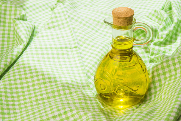 Olive oil on green tablecloth - Photo, Image
