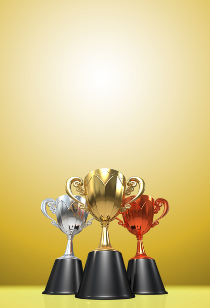 3D rendering gouden, zilveren en bronzen awards winnaars beker vergadering op gele Toon achtergrond. Drie cup trofeeën. Voor Bekerwinnaars. Kopiëren van ruimte op de top. - Foto, afbeelding