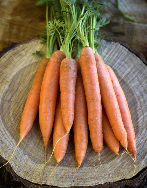 Fresh carrots bunch on rustic wooden background - Photo, Image