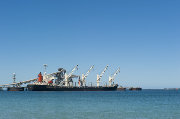 Freight vessel anchoring at jetty - Foto, afbeelding