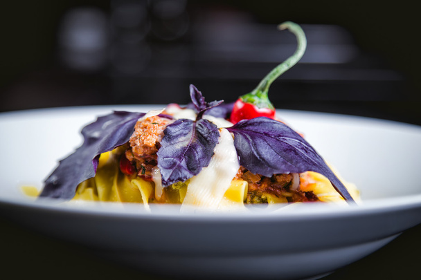 Italian pasta in a plate in a restaurant with chilli - Φωτογραφία, εικόνα