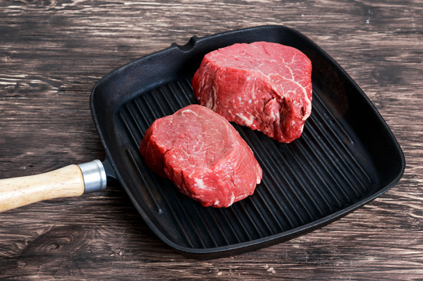 Fresh Raw Beef steak Mignon on grilled pan - Photo, Image