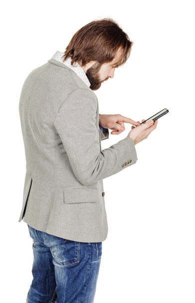bearded young business man using smartphone.  - 写真・画像
