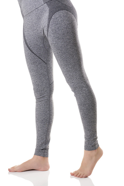 Close up view of woman legs from front side in gray sports thermo-underwear with pattern. - Photo, Image