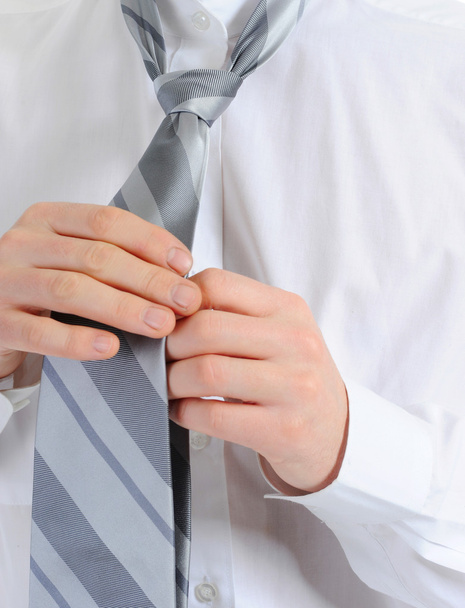 Businessman tying his tie - Foto, afbeelding