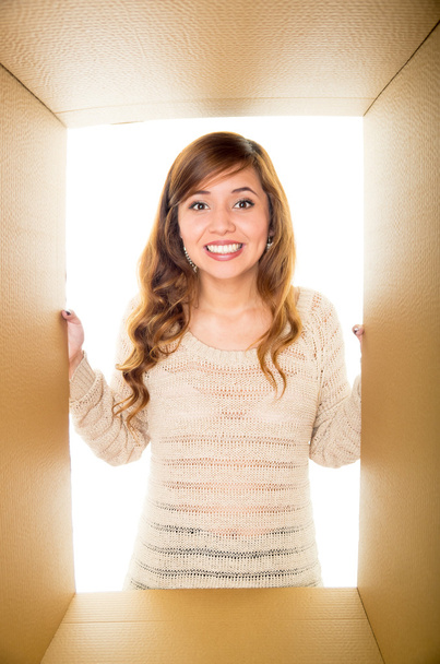 Smiling girl with light brown and wavy hair in the border of a box - Φωτογραφία, εικόνα