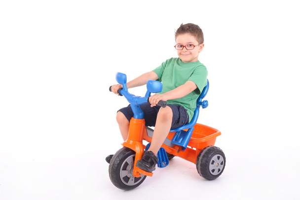 Young boy riding his tricycle - Zdjęcie, obraz