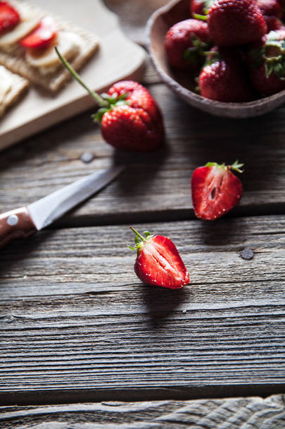 Fruity toast on wooden background. Strawberries, bread, butter and cheese.Vintage style - 写真・画像