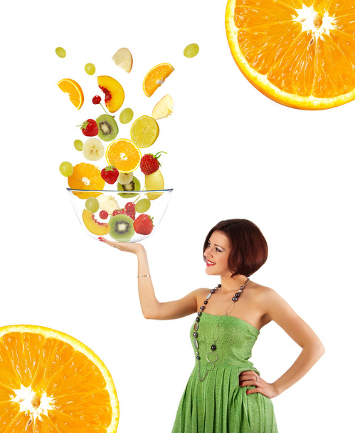 Beautiful young woman with a fruit salad - 写真・画像