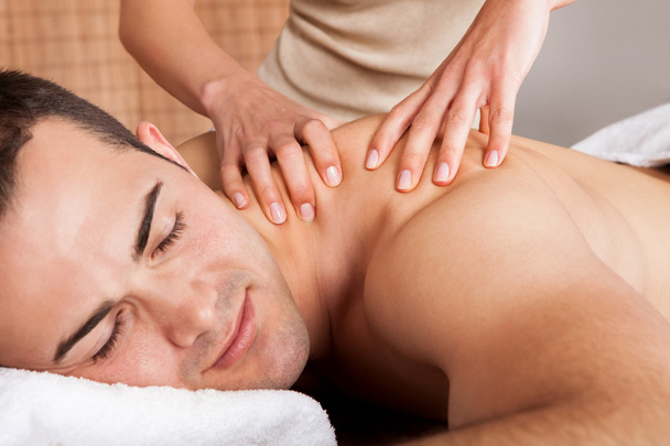 Young man getting shoulder massage - Valokuva, kuva