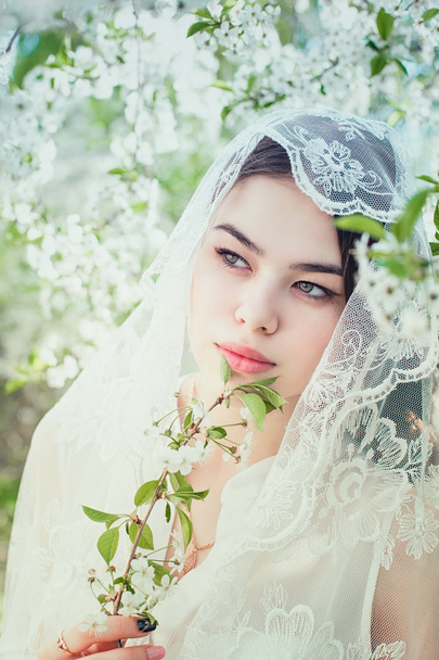 The girl in cherry blossoming garden - Фото, изображение