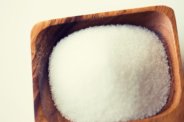 close up of white sugar heap in wooden bowl - Фото, зображення