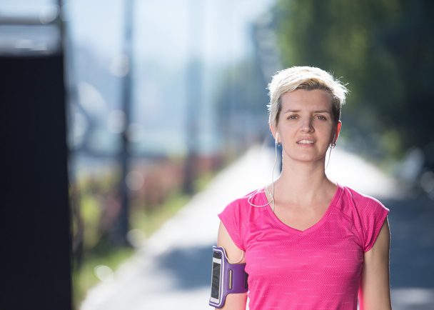 jogging woman setting phone before jogging - 写真・画像