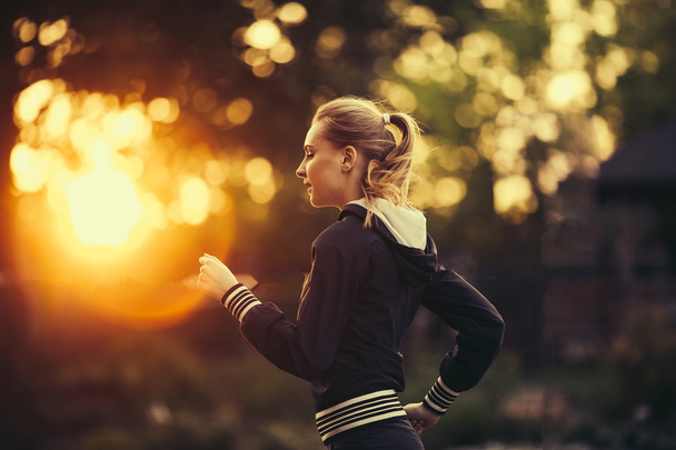 Pretty girl running on the park background - Foto, Bild