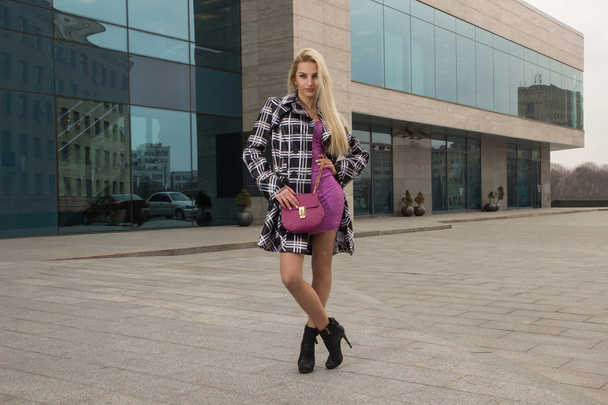 Blonde girl is posing in the city - Фото, изображение