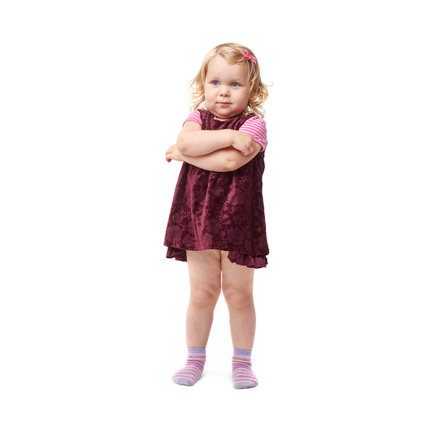 Young little girl standing over isolated white background - Foto, imagen