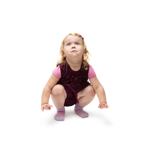 Young little girl sitting over isolated white background - Photo, Image