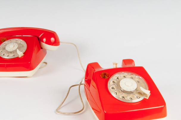 Telefone laranja retro com mostrador rotativo em branco
 - Foto, Imagem