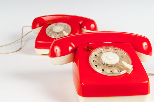 Retro orange telephone with rotary dial on white - Foto, afbeelding