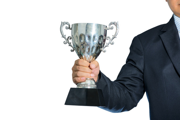 Businessman holding a champion silver trophy on white background - Photo, Image