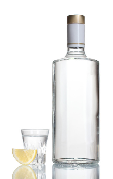 Bottle of vodka and wineglass with lemon isolated on white - Foto, Imagem