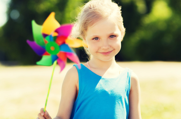 happy little girl with colorful pinwheel at summer - Photo, image