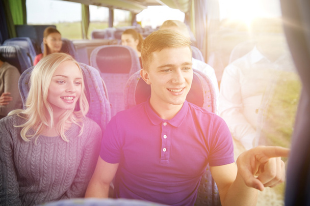 happy teenage couple or passengers in travel bus - Foto, Imagen