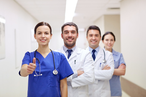 medics or doctors at hospital showing thumbs up - Фото, изображение