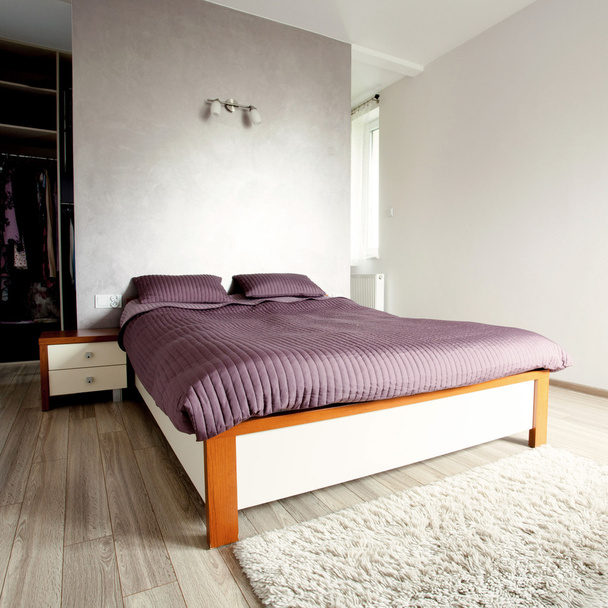 Comfortable bed in clean bedroom - Фото, изображение