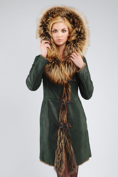 attractive lady in sheepskin coat with fur hood on head. perfect - Fotó, kép