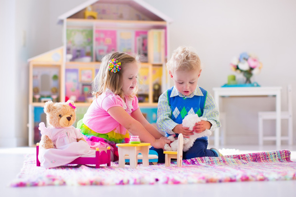 Kids playing with stuffed animals and doll house - Photo, Image